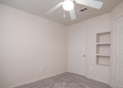Thumbnail 24 of 33 - an empty bedroom with a ceiling fan and a closet