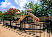 Thumbnail 28 of 33 - a playground with a slide at a park