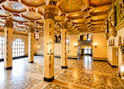 Thumbnail 4 of 16 - A large room with a stone floor and ornate ceiling.