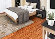 Thumbnail 9 of 16 - A bedroom with a bed, a ceiling fan, and a rug.