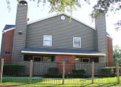 Thumbnail 3 of 26 - a large house with a fence in front of it