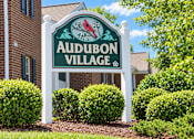 Thumbnail 8 of 50 - A sign for Audubon Village stands in front of a building.
