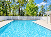 Thumbnail 15 of 50 - A rectangular pool with a white fence around it.