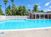 Thumbnail 17 of 50 - A pool with a house in the background.