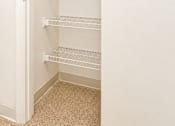 Thumbnail 29 of 50 - Empty white shelves in a white pantry.