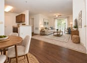 Thumbnail 23 of 50 - A modern living room with a dining table and chairs.