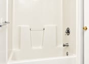 Thumbnail 38 of 50 - A white bathroom with a shower and a door.