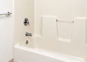 Thumbnail 39 of 50 - A white bathroom with a tub and shower.