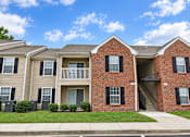 Thumbnail 46 of 50 - A row of houses with a clear blue sky above them.