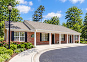 Thumbnail 3 of 50 - A small brick building with a black lamp post in front.