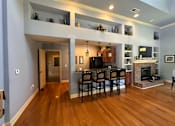 Thumbnail 4 of 4 - a living room with a fireplace and a table with chairs