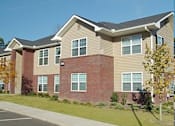 Thumbnail 6 of 6 - a large brick house with a sidewalk and grass
