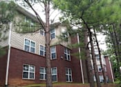 Thumbnail 2 of 6 - an apartment building with trees in front of it