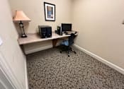 Thumbnail 2 of 4 - a small office with a desk and a computer