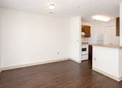 Thumbnail 14 of 19 - A kitchen with white cabinets and a wooden floor.