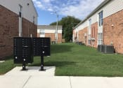 Thumbnail 14 of 17 - two mailboxes in the grass in front of a brick building