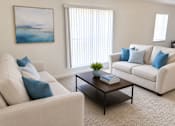 Thumbnail 3 of 18 - A living room with two couches and a coffee table.