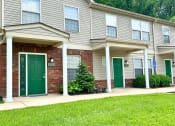 Thumbnail 10 of 12 - the front of a gray house with green doors