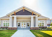 Thumbnail 5 of 13 - A modern building with a front porch and a covered entrance.