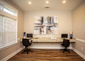 Thumbnail 9 of 13 - A room with a desk and two chairs.