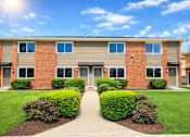 Thumbnail 10 of 14 - A sunny day at a residential building with a clear blue sky.