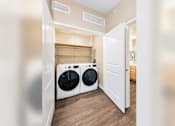Thumbnail 18 of 25 - A laundry room with a washer and dryer.