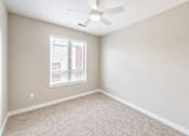 Thumbnail 19 of 25 - A room with a ceiling fan and a window with blinds.