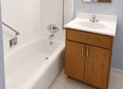 Thumbnail 10 of 12 - A white sink is on a counter in a bathroom.