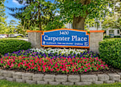 Thumbnail 3 of 12 - A sign for Carpenter Place with a phone number on it.