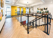 Thumbnail 9 of 25 - A black metal staircase with a wooden floor.