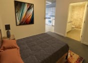 Thumbnail 5 of 9 - a bedroom with a bed and a painting on the wall at Lofts at Union Alley, Memphis