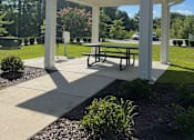 Thumbnail 2 of 9 - a pavilion with a picnic table in a park