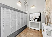 Thumbnail 6 of 13 - A row of white lockers in a room with a vase of flowers on a table.