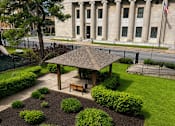 Thumbnail 7 of 16 - A large building with columns and an American flag on top.