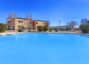 Thumbnail 7 of 9 - a large swimming pool with a building in the background