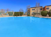Thumbnail 8 of 9 - a large swimming pool with a building in the background