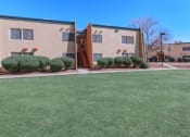 Thumbnail 6 of 9 - a lawn in front of an apartment building