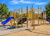 Thumbnail 4 of 14 - A playground with a yellow structure and a blue slide.