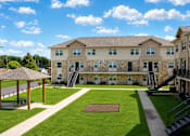 Thumbnail 5 of 5 - A large building with a gazebo in front of it.