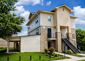 Thumbnail 4 of 5 - A two-story house with a balcony and a staircase leading to the second floor.