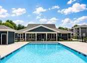 Thumbnail 20 of 22 - A swimming pool in front of a house.