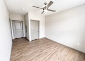 Thumbnail 21 of 22 - A room with a ceiling fan and two doors.