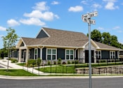 Thumbnail 1 of 22 - A house with a sign that says "Flower Trace" in front of it.