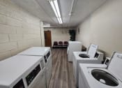 Thumbnail 4 of 7 - an empty laundry room with washing machines and dryers