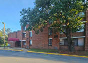 Thumbnail 6 of 7 - a large brick building with a tree in front of it