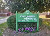 Thumbnail 1 of 7 - a sign gardens in front of a tree