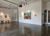 Thumbnail 16 of 16 - A room with a grey floor and a painting on the wall.