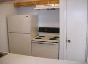 Thumbnail 5 of 7 - a white kitchen with a stove and a refrigerator