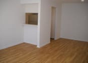 Thumbnail 7 of 7 - an empty room with a white wall and wooden floors