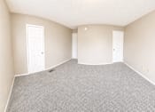 Thumbnail 18 of 23 - A room with grey carpet and white doors.